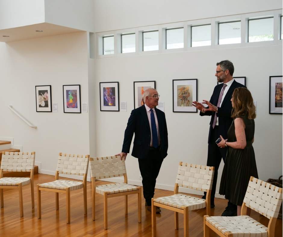Three people chatting in the chapel
