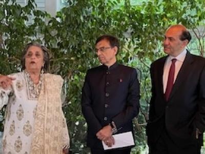 One woman and two men speaking